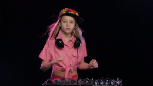 Teenage Girl Plays Music and Dances at Dj Table. Studio