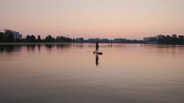 Sunset Woman Silhouette on Lake Stand Up Paddle Board SUP Wide View