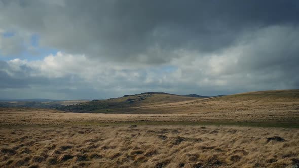 Passing Sunny Hills In Wild Landscape