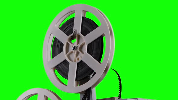 Film Is Wound Onto a Cassette Projector. Studio Green Screen