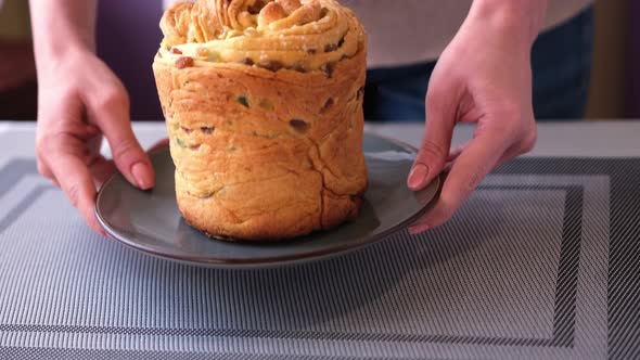 Young Woman Puts Fresh Baked Easter Cake Cruffin on Kitchen Table