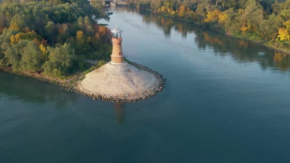 Amazing aerial drone footage of Danube river with old lighthouse on the beach. 4K video of nature by