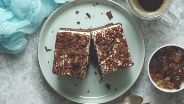 Delicious Chocolate Cake with Layers Served on Ceramic Blue Plate. With Cup of Fresh Black Coffe