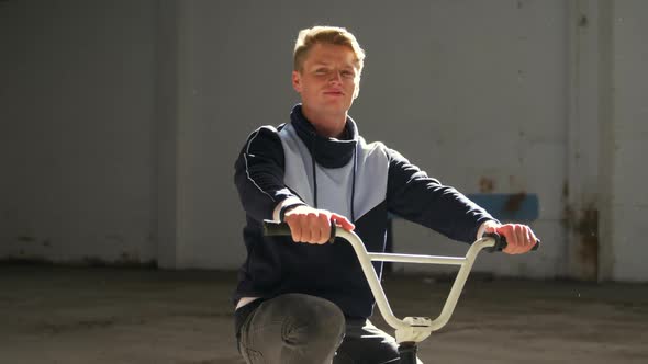 BMX rider in an empty warehouse