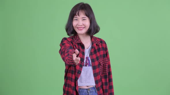 Happy Asian Hipster Woman Pointing at Camera