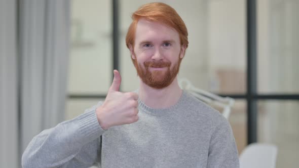 Portrait of Young Redhead Man Showing Thumbs Up Sign 