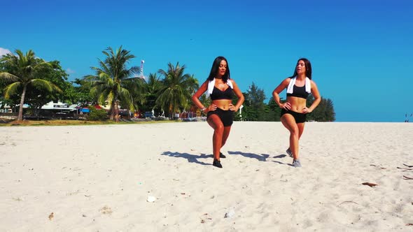 Beautiful ladies happy and smiling on relaxing lagoon beach voyage by clear lagoon and white sandy b