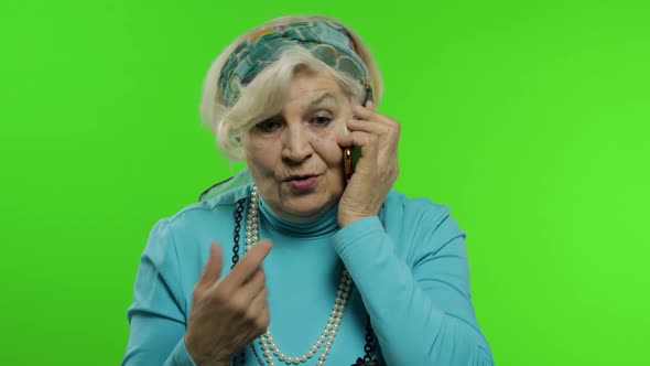 Elderly Stylish Caucasian Grandmother Woman Talking on Mobile Phone. Chroma Key