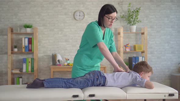 Physical Therapist Doing Back Massage Young Boy