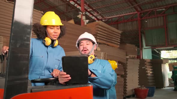 Industrial engineer workers team inspect cardboard storage at factory warehouse.