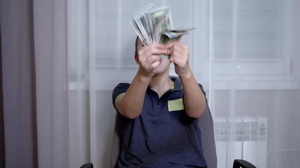 Happy Laughing Teen Scatters a Lot of Money in Room