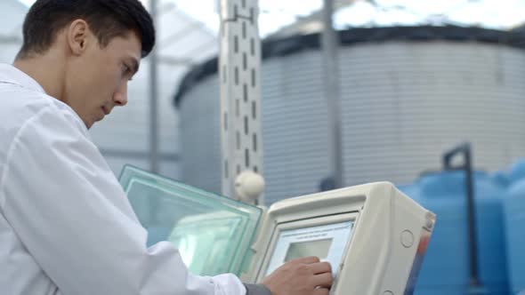 Agronomist Turning On Fertigation Machine