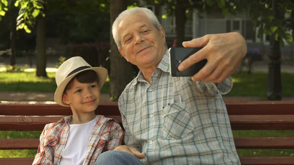 Senior Man Takes Selfie with His Grandson
