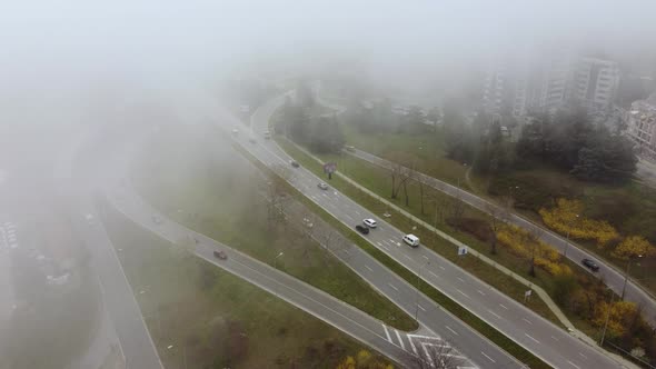 Road Traffic in the City in the Fog at the Summer Day Aerial View