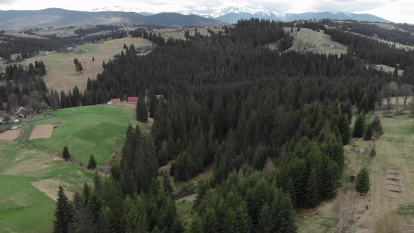 Snowy mountain peaks and cloudy sky. Carpathian mountains from bird's eye view.