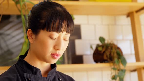 Beautiful waitress standing in cafe 4k