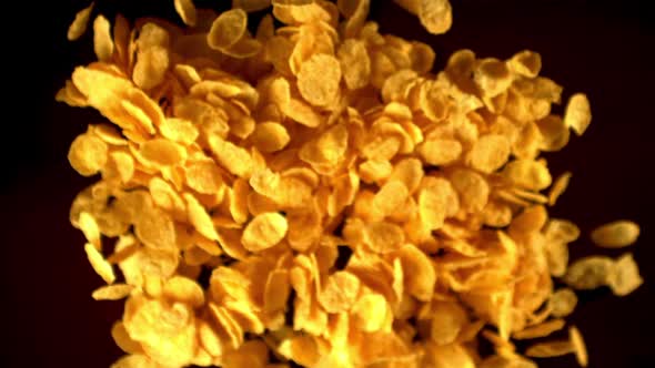 Super Slow Motion Cornflakes Take Off Against a Black Background