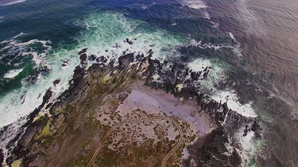 Aerial view of waves crashing on coastline