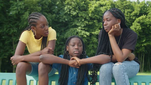 Chatting Cute Black Teenage Girls Relaxing on Bench in Summer Park