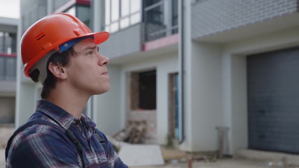 Back Side View of a Young Man in Orange Helmet