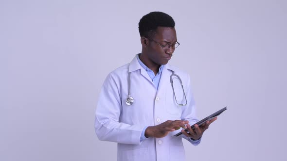 Young Happy African Man Doctor Using Digital Tablet