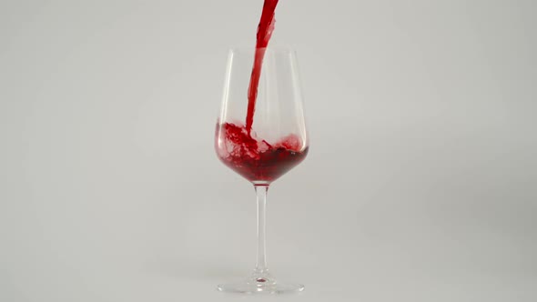 Pouring Red Wine in Glass at 1000 Fps Super Slow Motion Shot White Background