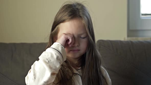 A 67 Year Old Girl Who Has Just Woken Up Rubs Her Eyes