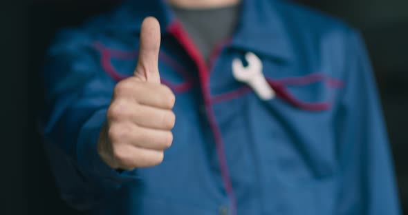 Close Up of Professional Mechanic in Uniform Gesturing Thumb Up To Camera, Approval Concept