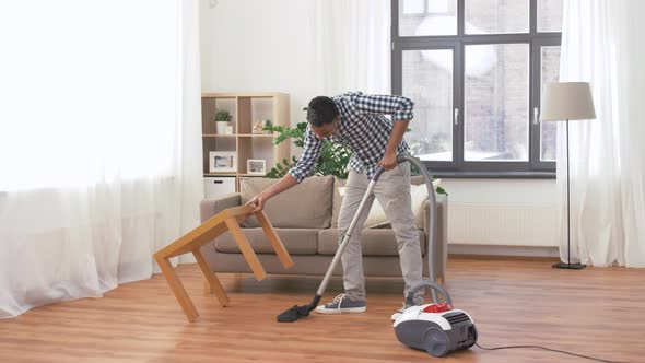 Man with Vacuum Cleaner at Home 