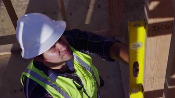 Construction worker checking a level