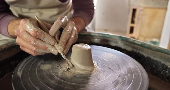 Male potter making pot