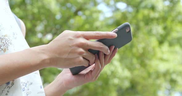 Woman using mobile phone over green background 