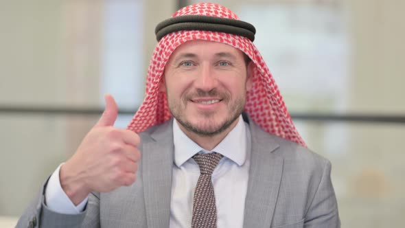 Portrait of Middle Aged Arab Businessman showing Thumbs Up Sign