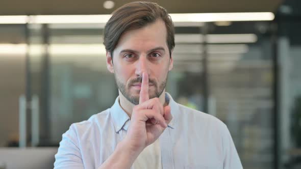 Mature Adult Man Showing Quiet Sign Finger on Lips