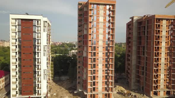 Aerial view of tall residential apartment buildings under construction. Real estate development.