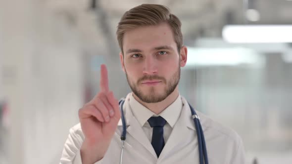 Male Doctor Showing No Sign with Finger Gesture