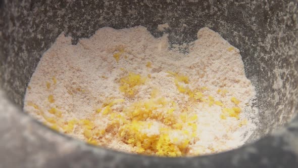 Closeup of Lemon Zest Falling Into the Mortar Full of Brown Sugar and Salt
