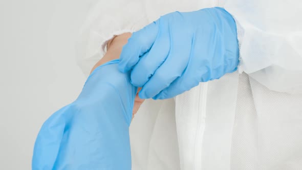 CLoseup of Female Docto Putting on Protective Rubber Gloves in Hospital