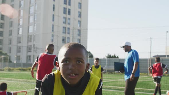 African American soccer kid exercising in a sunny day