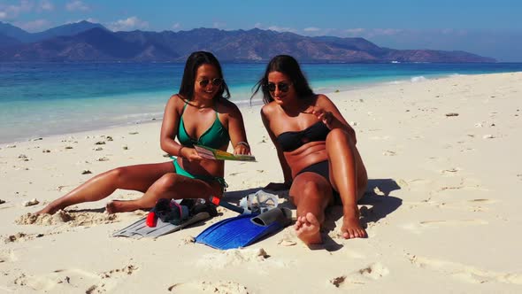 Ladies together tan on tropical lagoon beach wildlife by shallow ocean with white sand background of