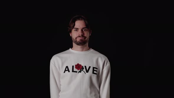 Trendy Young Man expressing disappointment, lack of surprise, wide, black background