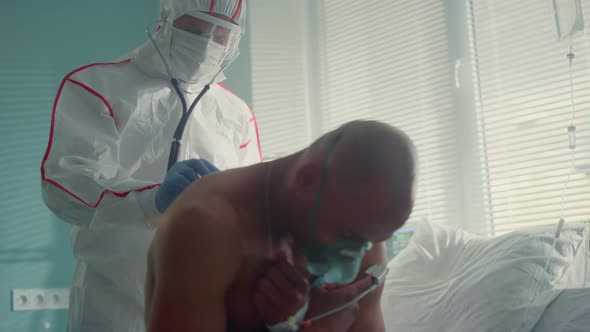 Sick Patient Oxygen Mask Undergoing Physician Examination in Hospital Ward