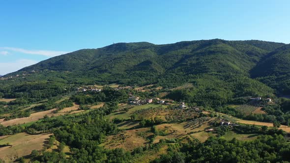 Aerial scenic panoramic landscape of the countryside. Houses stretch along the top of the mountain