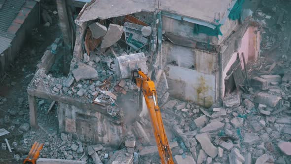 Destroying Old House Using Bucket Excavator on Construction Site. alt