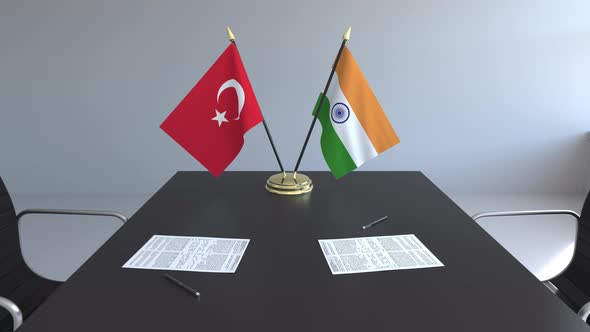 Flags of Turkey and India and Papers on the Table