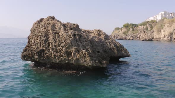 Big Rock in Turquoise Sea Water