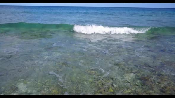 Aerial scenery of tranquil tourist beach holiday by turquoise sea and white sandy background of a da