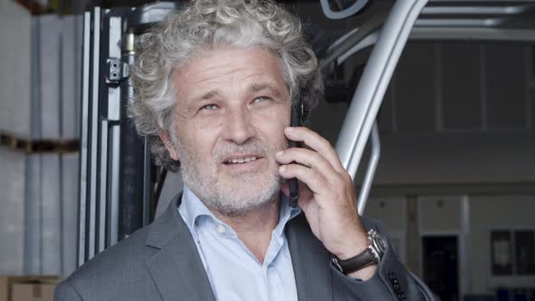 Closeup of Pensive Businessman Talking on Phone