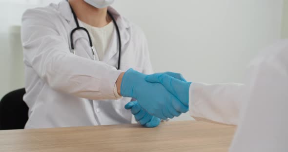 Close Up Human Palms Two Doctors in Protective Latex Gloves Shaking Hands After Working Together in