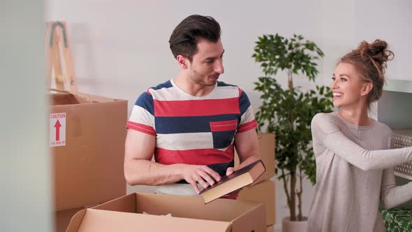 Couple unpacking their stuff to new home  